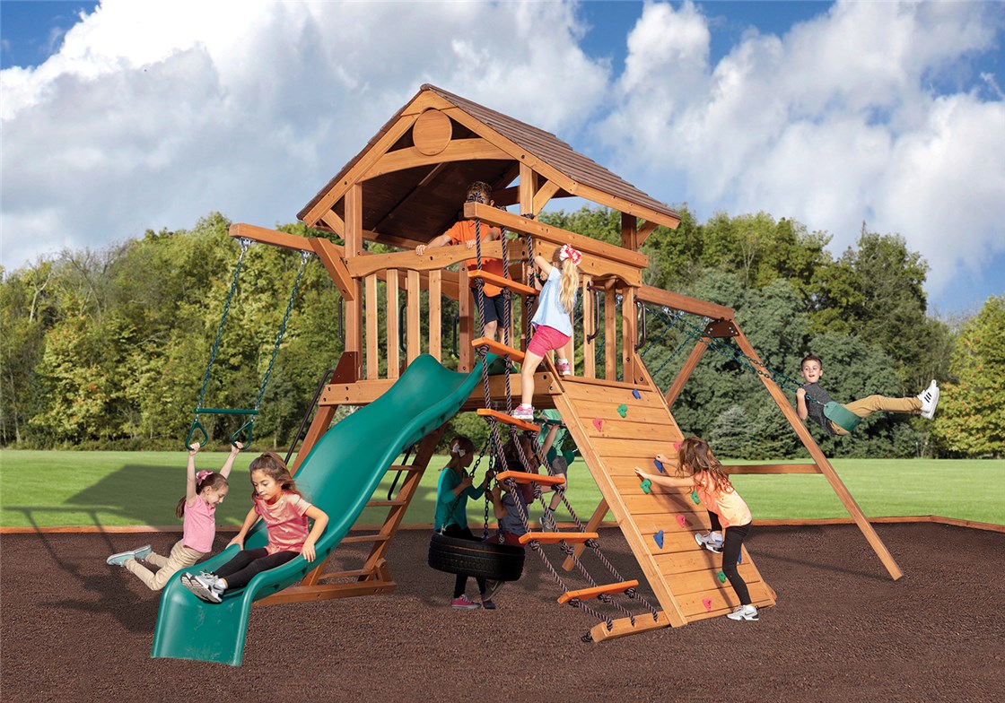 kids playing on a backyard playset with swings