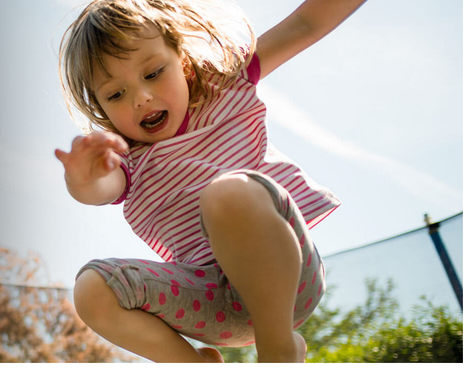 Girl leaping on a trampoline
