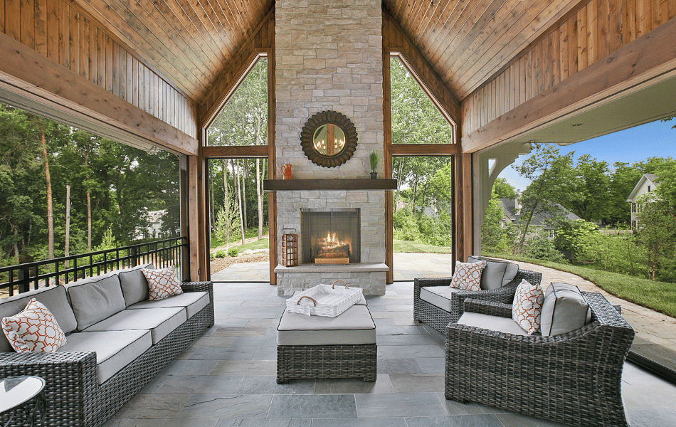 covered backyard living room with fireplace