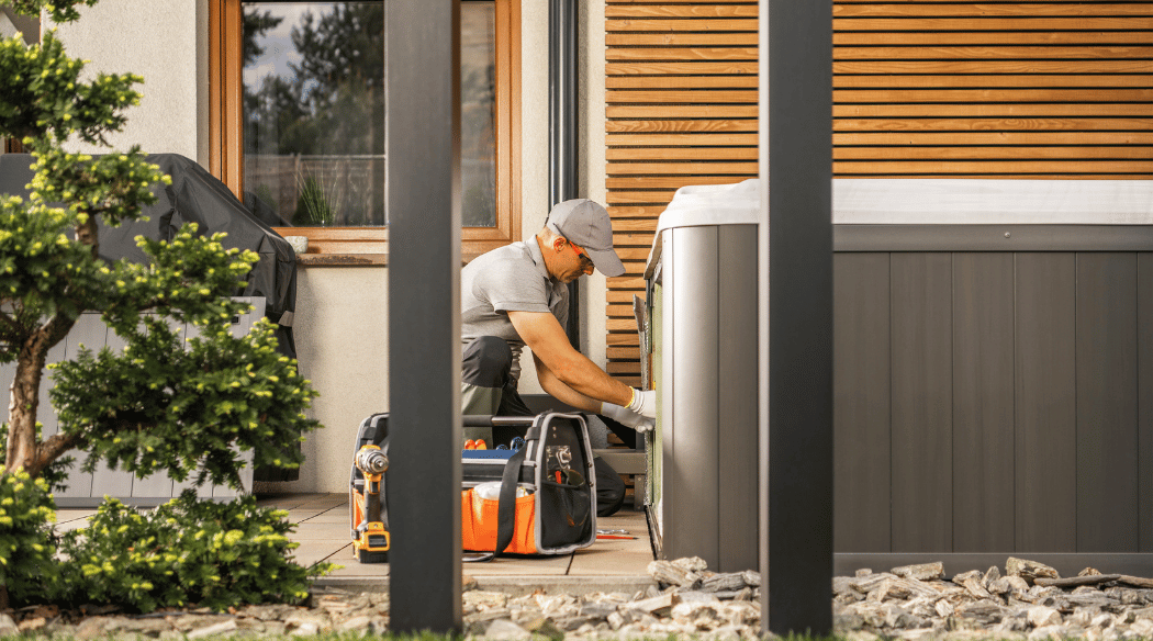 Guy installing an outdoor hot tub home spa