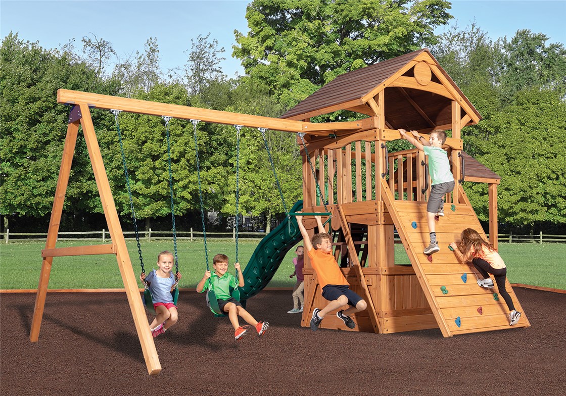 Kids playing on a wood play swing set